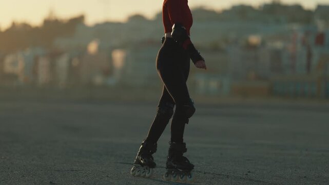 Young woman inline skating at sunset