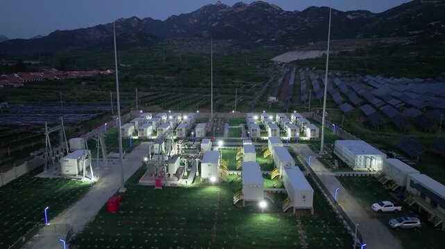 Modular dormitory complex illuminated at night within a mountainous photovoltaic power park