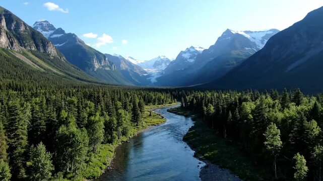 Scenic aerial view of a winding river surrounded by lush green forest and majestic mountains under a clear blue sky