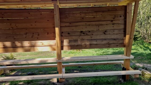timber framing, similar to log cabin construction, giving it a sturdy and durable appearance. pillars are made of thick, round logs. Roof Design steep A frame roof covered with asphalt shingles.
