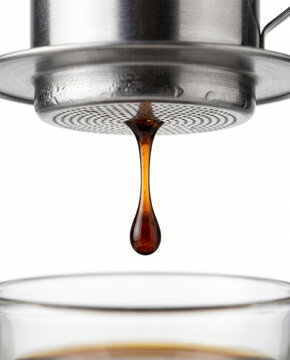 coffee drop falling from vietnamese phin filter into glass cup