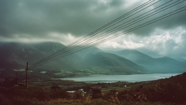 Misty Mountain Landscape with Lake and Power Lines.