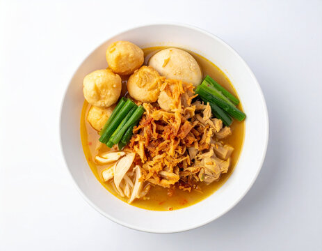 Curry soup with meatballs and egg in white bowl
