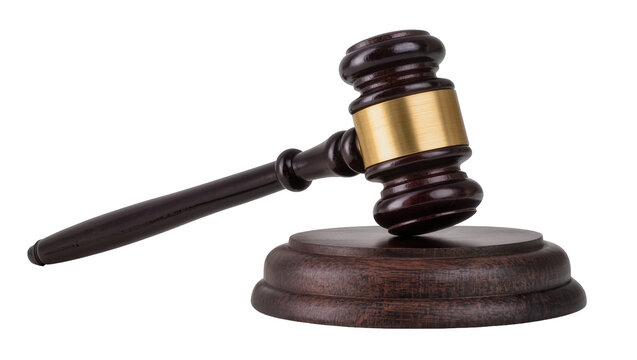 Wooden gavel with brass band resting on dark wooden base