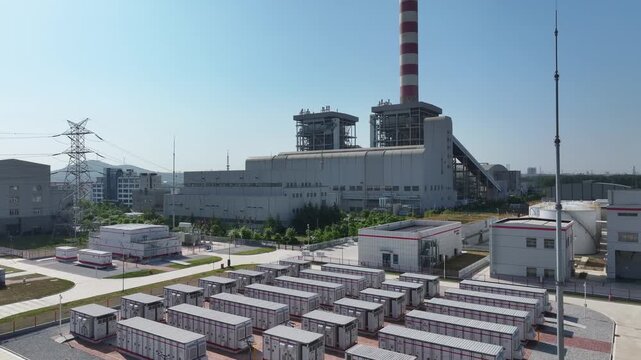 Thermal power plant industrial area with rows of energy storage equipment under clear sky
