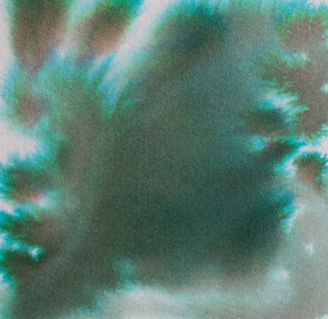 Watercolor painting ink creating an abstract background texture with blending green and blue hues spreading organically across the surface, offering a calming, organic feel