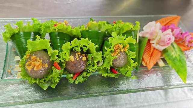 Sakoo Sai Moo, traditional Thai tapioca dumplings served in banana leaf cones.