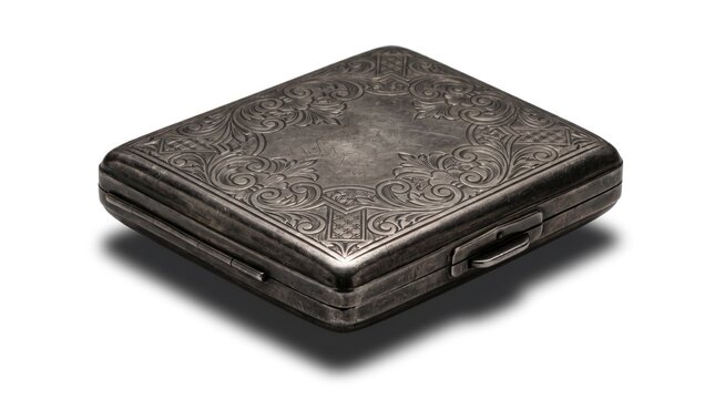 Antique silver cigarette case with ornate design on white background