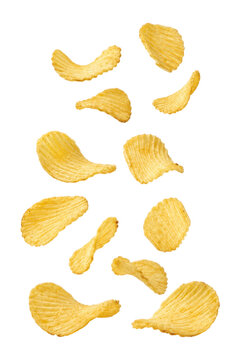 Crispy ridged potato chips isolated on light gray background, crunchy snack texture with golden wavy slices arranged in floating composition