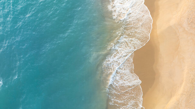 Tropical beach landscape from drone perspective showing turquoise sea and smooth sand coastline. Minimal natural background ideal for travel websites, resort promotions, and summer design projects.
