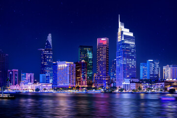 Fototapeta premium Coastline with skyscrapers of Ho chi minh or Saigon city in Vietnam, night panorama