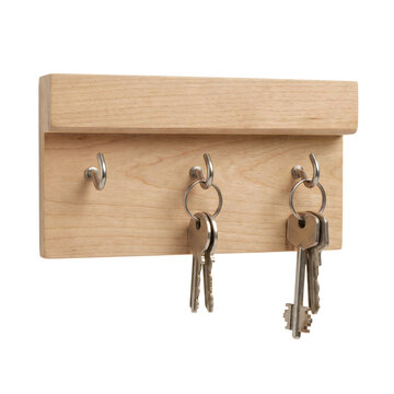 A simple wooden key holder with silver hooks displays three sets of keys against a white background.