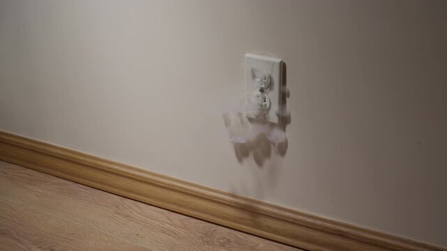 A short circuit  caused smoke and sparks in a socket