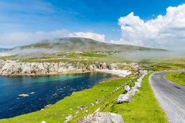 Obraz premium Misty White Cliffs of Ashleam on Achill Island, County Mayo, Ireland. Dramatic Atlantic sea cliffs and turquoise water on the Wild Atlantic Way.