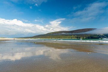 Obraz premium Keel Beach on Achill Island, County Mayo, Ireland. Misty cliffs, gentle waves and Atlantic shoreline on the Wild Atlantic Way.