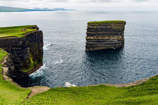 Aerial view of Dun Briste sea stack at Downpatrick Head, County Mayo, Ireland. Spectacular layered cliffs and Atlantic waves on the Wild Atlantic Way.