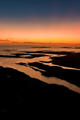 Obraz premium Sunset glows over Clifden Bay and the Atlantic islands from the Sky Road viewpoint in Connemara, County Galway. Aerial scenic view from one of Irelands best coastal lookouts. Wild Atlantic Way.