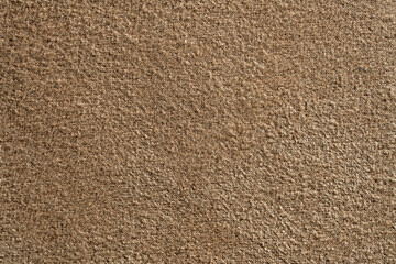 Closeup of brown carpet texture or wool felt fabric. High quality seamless style background for interior design, textile industry, and commercial upholstery concepts © OlegD