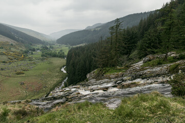 Obraz premium Misty mountain stream near Glenmacnass Waterfall in County Wicklow, Ireland. Wild Irish landscape in Wicklow Mountains National Park near Sally Gap.
