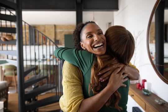 Two friends greeting each other with a warm hug