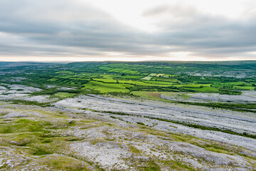 Obraz premium Aerial view of Burren National Park in County Clare, Ireland. Dramatic limestone karst landscape on the Wild Atlantic Way with green fields and wild countryside.