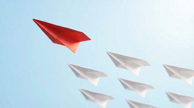 Red paper plane leading a group of white planes against a blue background representing leadership and business success.
