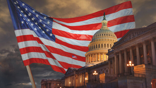  US Capitol building at night with an American flag in the background, Washington DC, USA. Happy 4th of July &ndash; Independence Day!