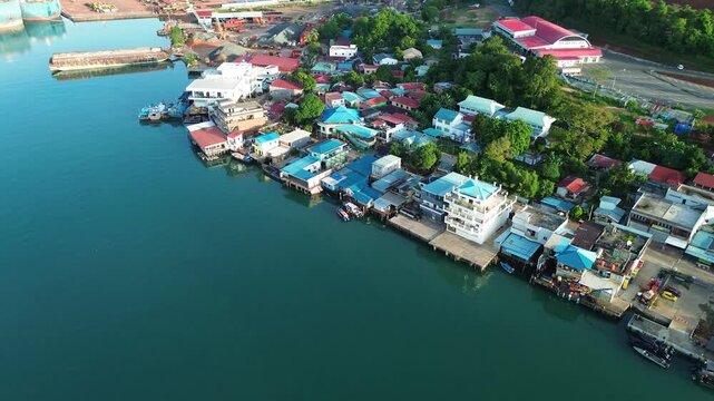 Batam Island's vibrant coastal settlement. an aerial symphony of homes and bustling maritime life