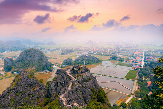Scenic sunset over Ninh Binh Vietnam with mountains and rice fields