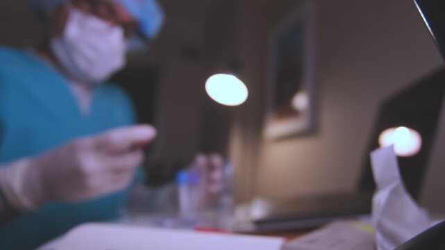 Medical researcher examining a test tube containing a blood sample in a laboratory
