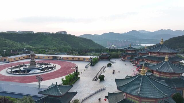 Panoramic view of the Guanyin Dharma Realm complex on Mount Putuo in Zhejiang with traditional Chinese temple architecture and mountain backdrop