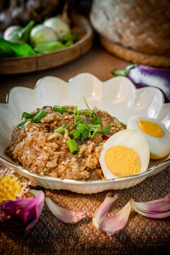 Healthy Thai pounded eggplant salad with boiled egg and herbs. Known as Tam Ma Khua in Northern Thailand or Soup Ma Khua in Isan, representing authentic regional Asian rustic home-cooked dining.