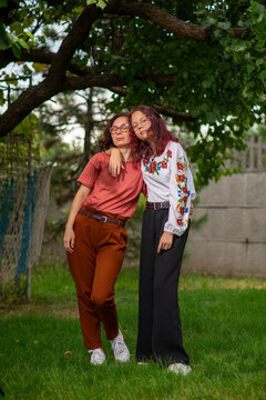 Two Friends Embracing in a Sunny Garden