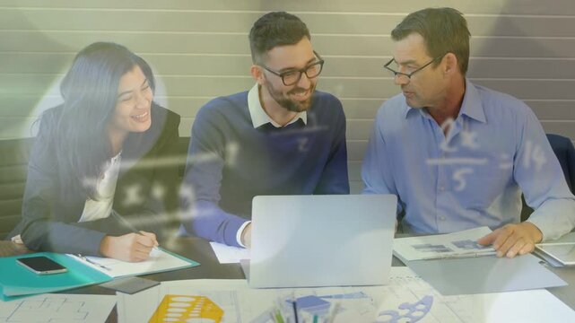 Design team reviewing plans at laptop, center typing, initiating math symbols overlaying table