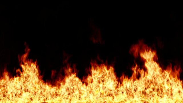 Raging Wall of Fire Burns Intensely on a Dark Background in an Endless Loop