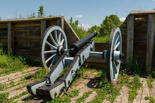 Revolutionary War cannon set within wooden defensive earthworks at Valley Forge on a clear spring day.