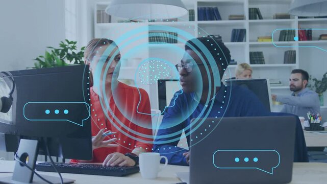 Woman typing keyboard activating blue HUD and chat icons while man leaning in during business sync