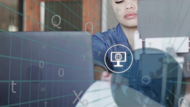 Woman at desk responding to tech notifications appearing on laptop, reaching and reading documents