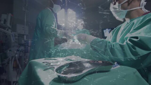 Foreground surgeon receiving, inspecting forceps following request, managing handoffs in surgery
