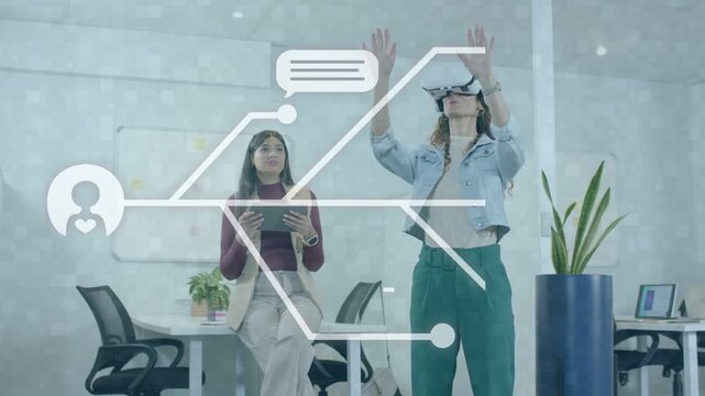 VR user raising hands and seated woman tapping tablet running AR demo showing chat bubbles pulsing