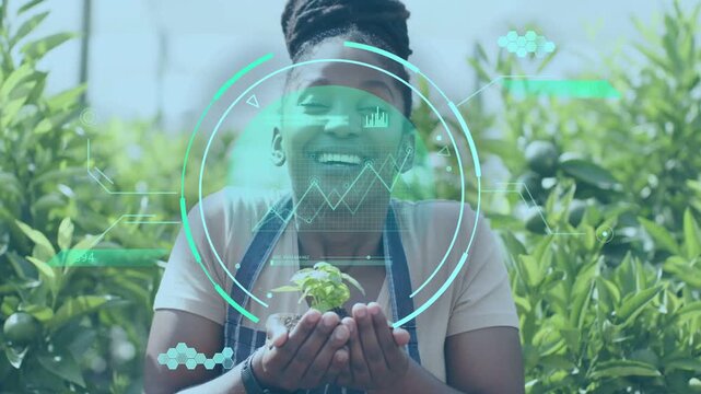 Female gardener holding seedling in orchard, teal scan appearing over hands analyzing plant health