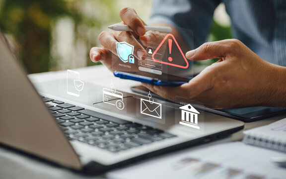 Cybersecurity concept. Man using smartphone with hacking warning alert, phishing scam on email and credit card, and data protection icons.