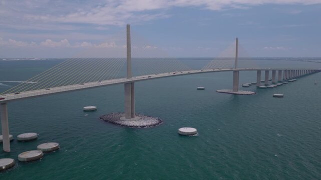 Cinematic aerial drone push toward Sunshine Skyway Bridge over Tampa Bay
