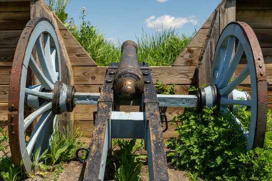 Revolutionary War cannon set within wooden defensive earthworks at Valley Forge on a clear spring day.
