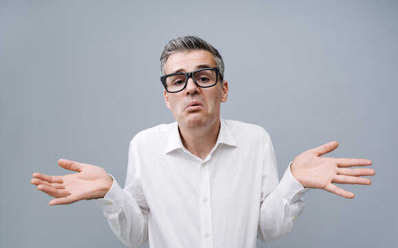 Clueless confused man shrugging