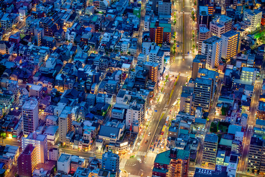 Breathtaking aerial view of Tokyo at night from a high vantage point, showcasing the glittering neon skyline