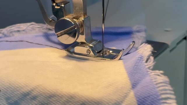 Sewing machine in motion stitching with black thread 