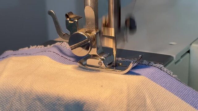 Sewing machine in motion stitching with black thread 