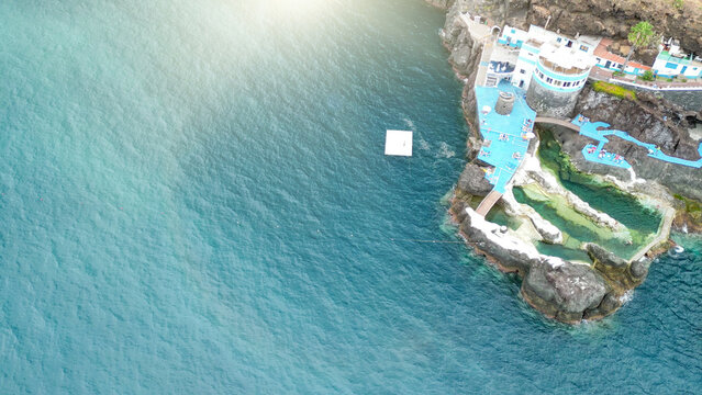 Dramatic aerial drone view of Doca do Cavacas natural volcanic pools and rugged Madeira cliffs