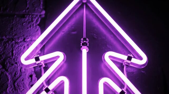 Bright purple neon arrow illuminating a dark brick wall